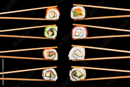 Sushi pieces in chopsticks