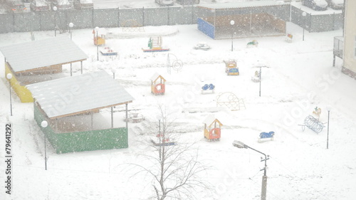 swirling flakes of snow on the playground