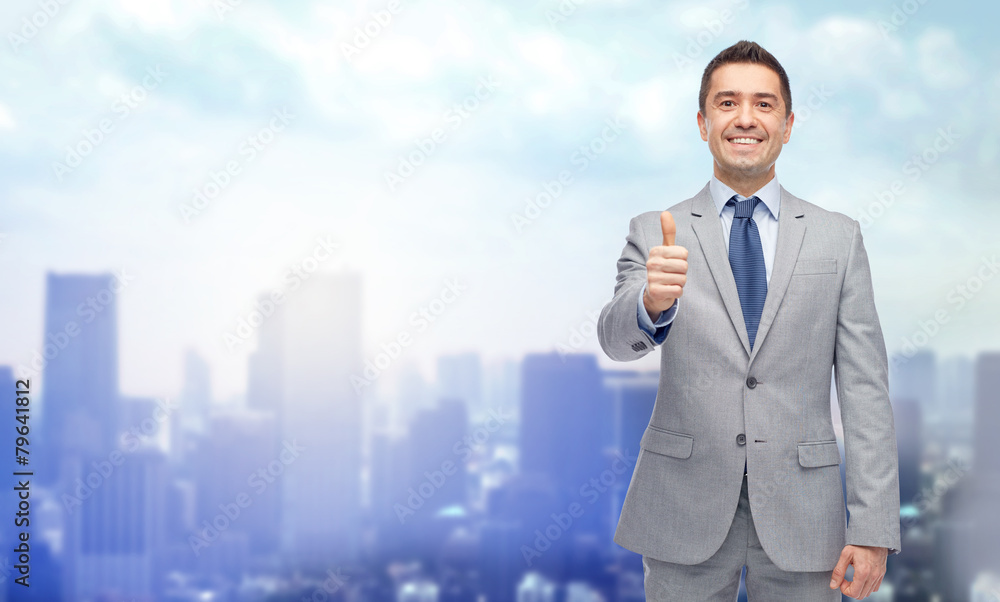 happy businessman in suit showing thumbs up happy businessman in suit showing thumbs up