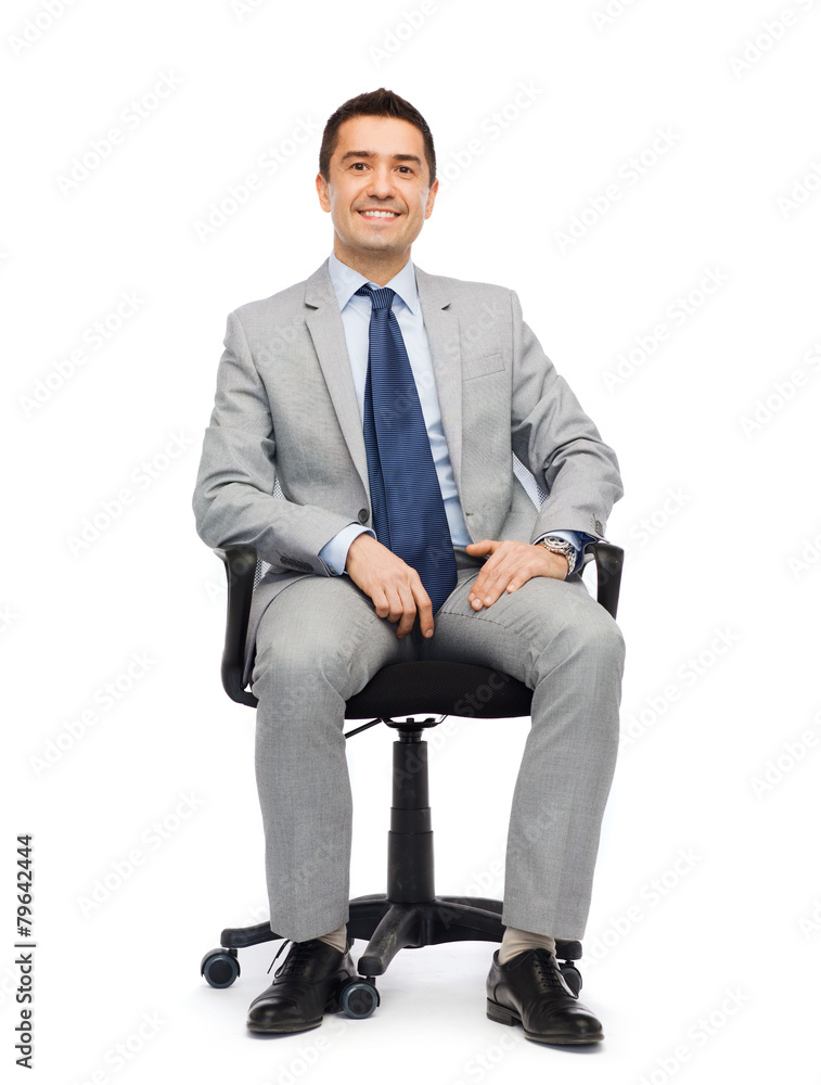 happy businessman  sitting in office chair
