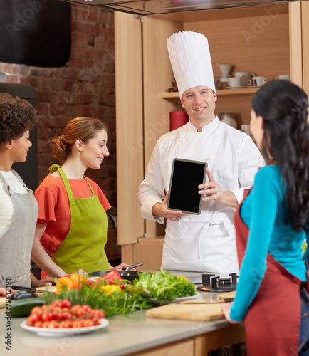 happy women with chef and tablet pc in kitchen