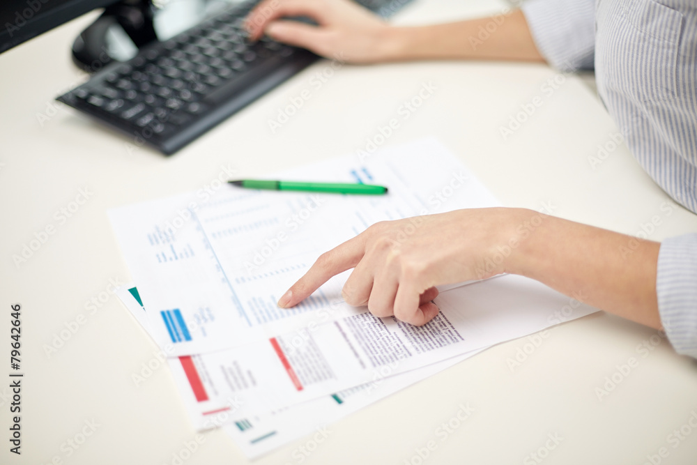 close up of woman hands with papers and computer close up of woman hands with papers and computer