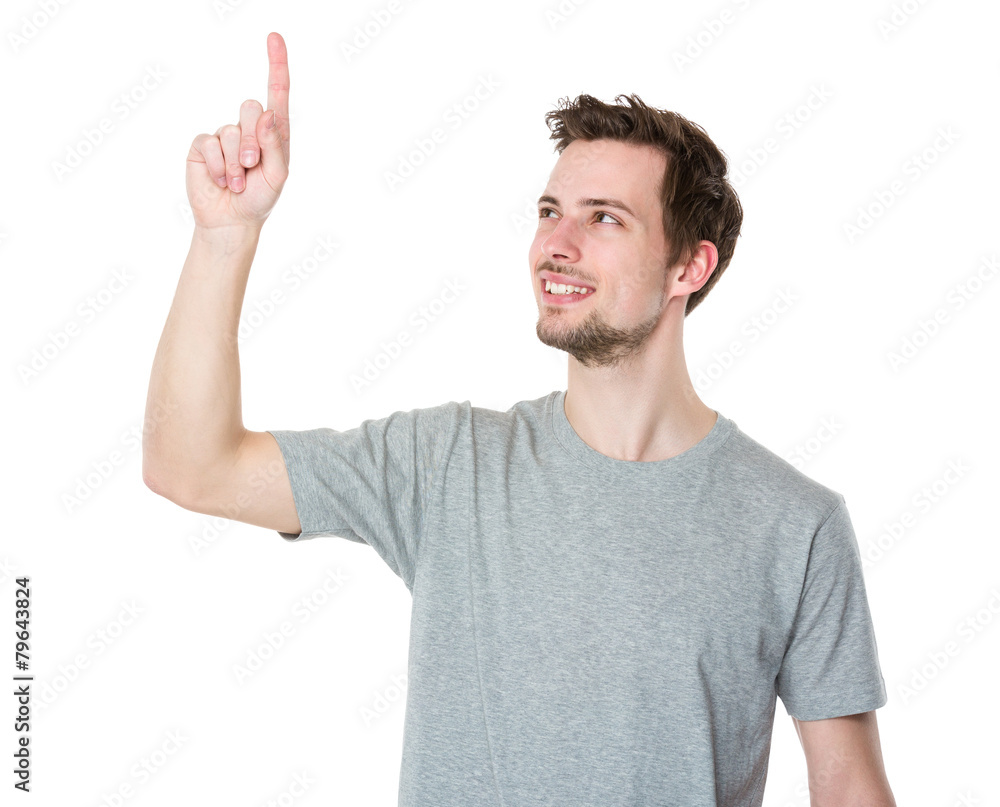 Young casual man selecting or pushing a button Young casual man selecting or pushing a button