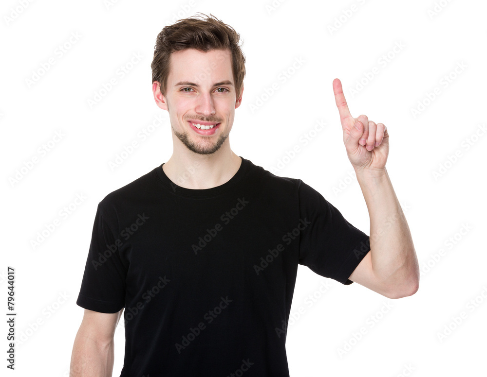 Cheerful young man pointing towards something interesting Cheerful young man pointing towards something interesting