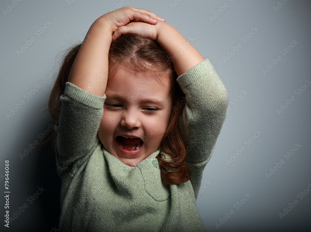 Angry kid girl shouting with open mouth and holding the head Stock ...