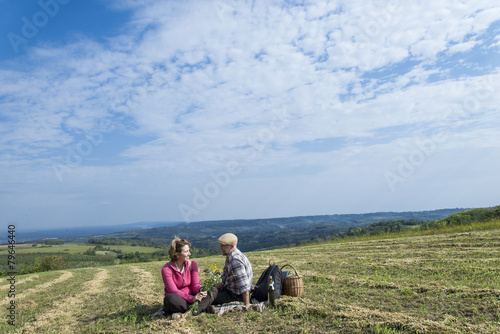 Senior couple sitting in the field