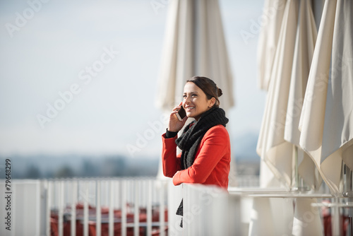 Smiling woman on a terrace © StockPhotoPro