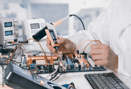 Repairman fixes electronic equipment