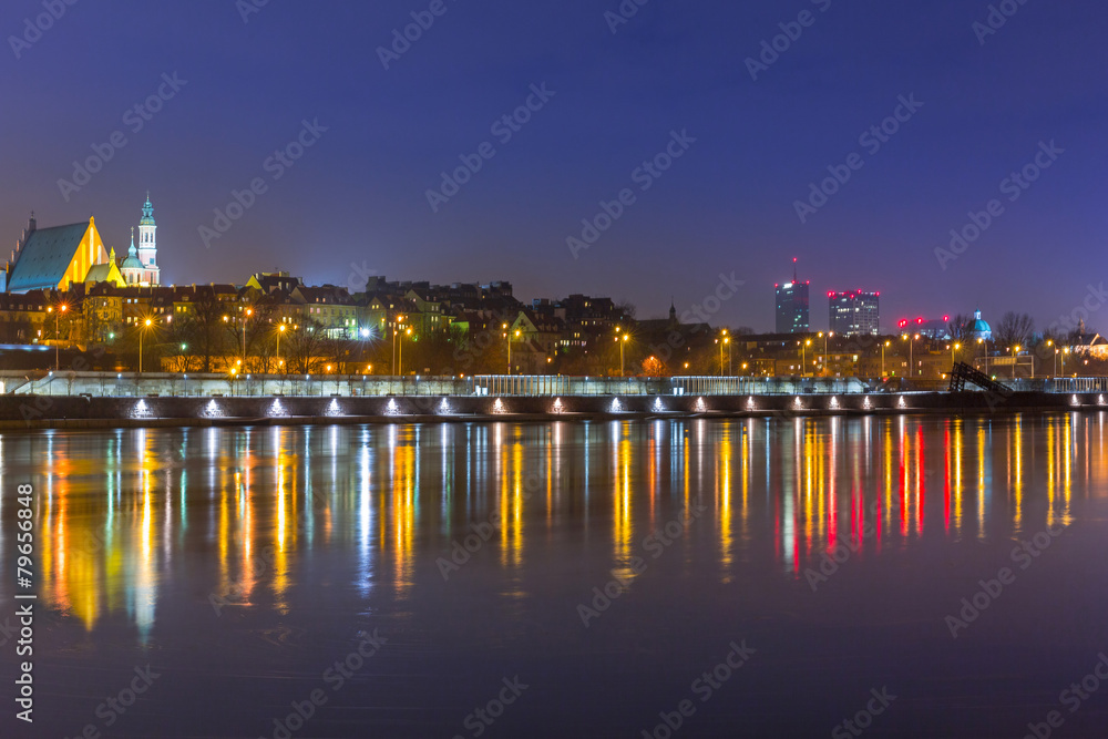 Panorama of Warsaw at night with reflection in Vistula river