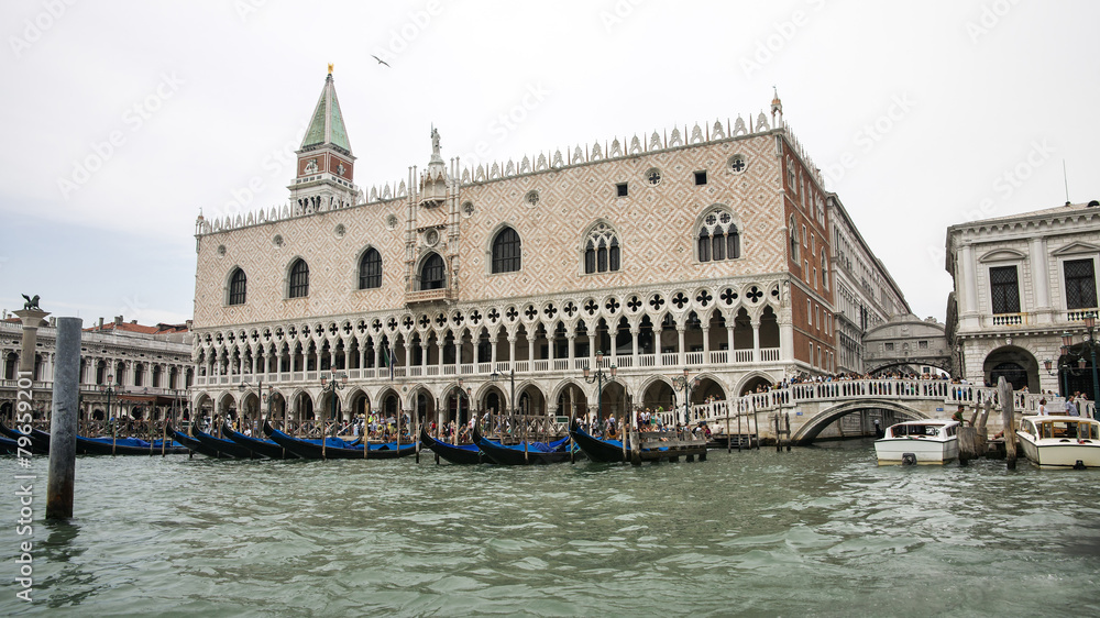 Gondolas parking near Doges palace in summer Venice