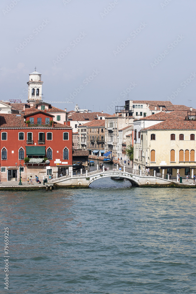 Quay and pedestrian bridge over channel in Venice