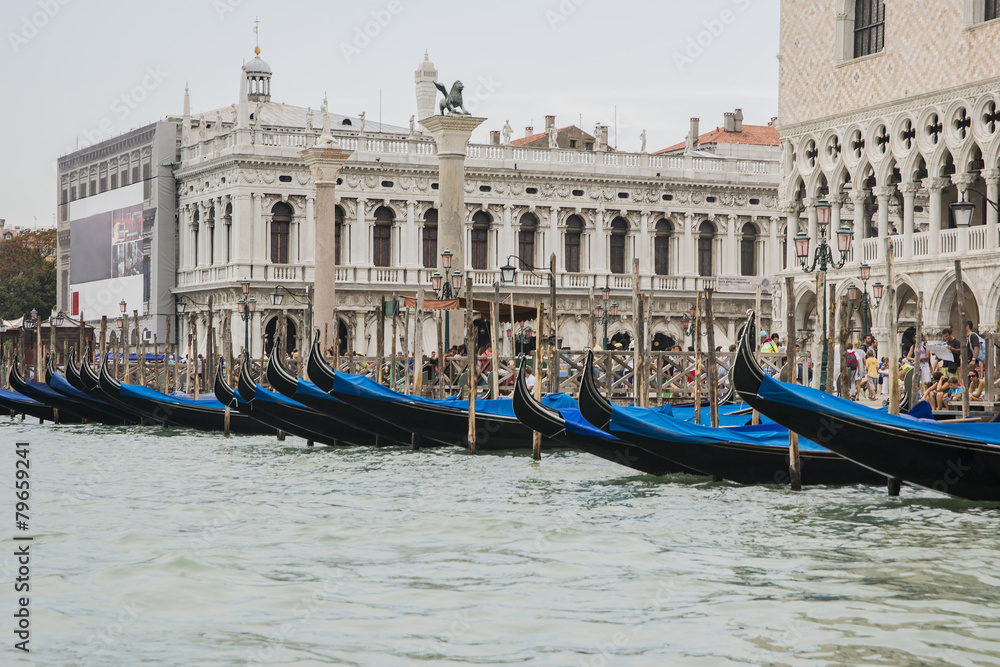 Row of gondolas near Doges palace in summer Venice