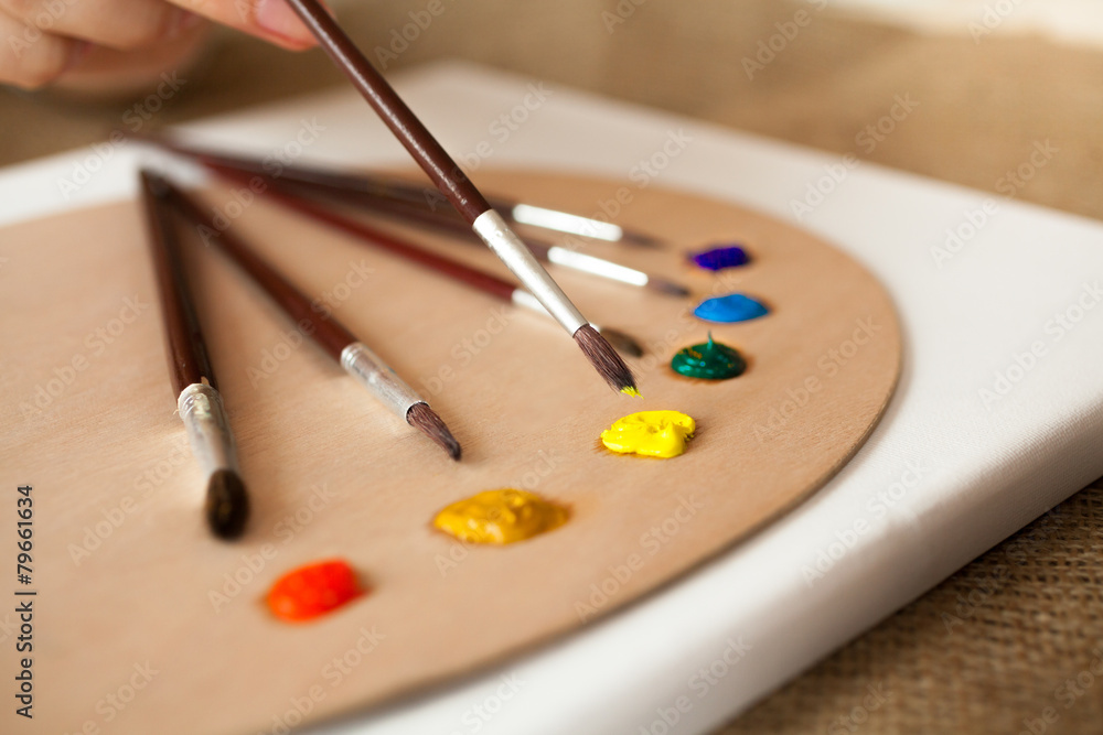 professional paintbrushes lying on pallet dipped in oil paint professional paintbrushes lying on pallet dipped in oil paint