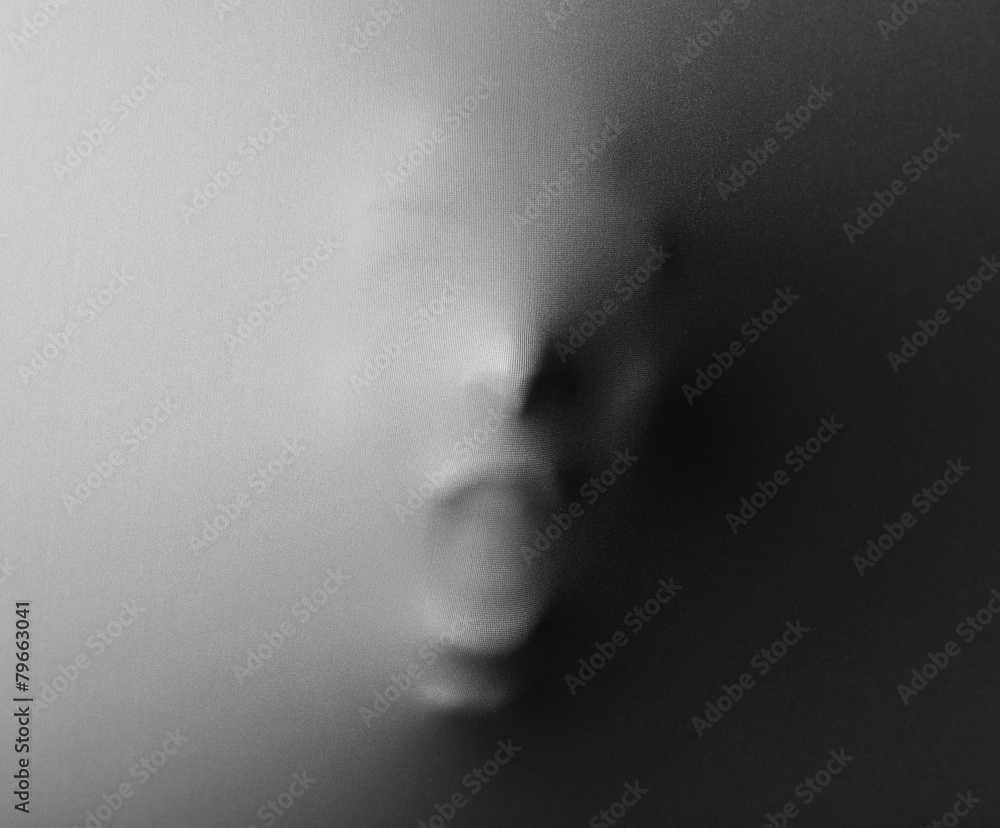 Screaming human face pressing through fabric as horror Screaming human face pressing through fabric as horror