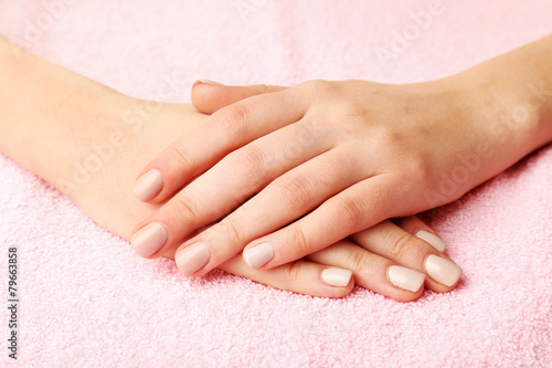 Beautiful female hands on fabric background