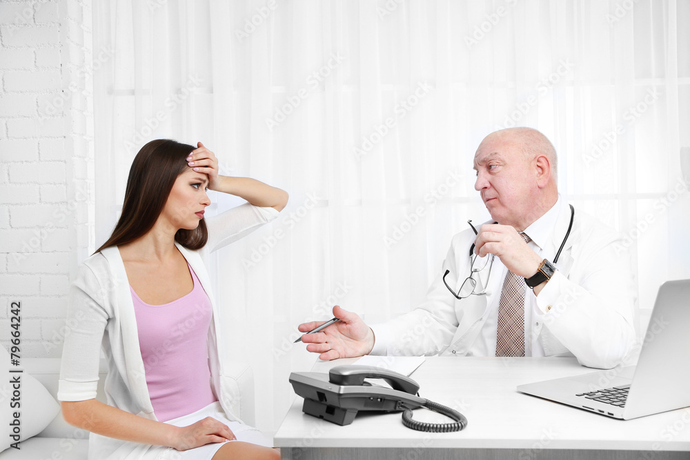 Fototapeta premium Professional doctor receiving patient in his office