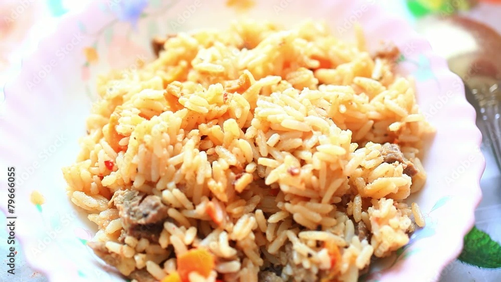 Chef is putting Khan Pilaf on a plate at the restaurant and Chef is putting Khan Pilaf on a plate at the restaurant and