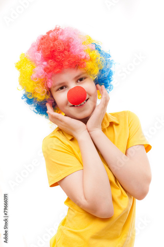 the boy with a red clown nose and bright wig