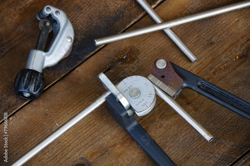 Tapeta Tube bender or pipe bender tools on wooden background.