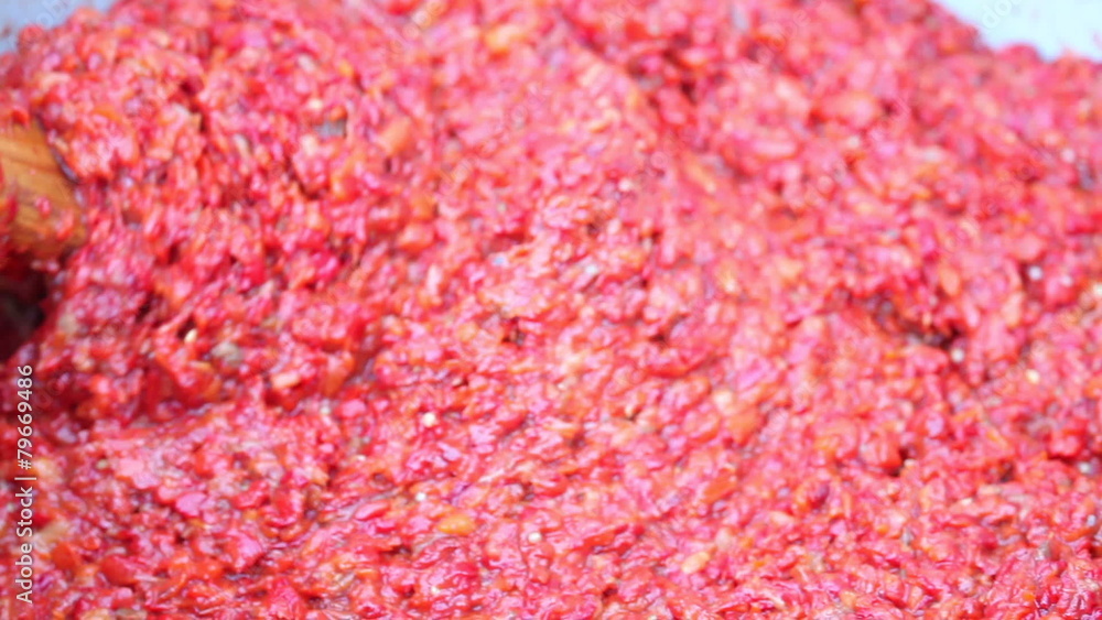 mixing ajvar with wooden spoon mixing ajvar with wooden spoon