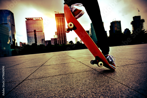 skateboarder jump at city skatepark 