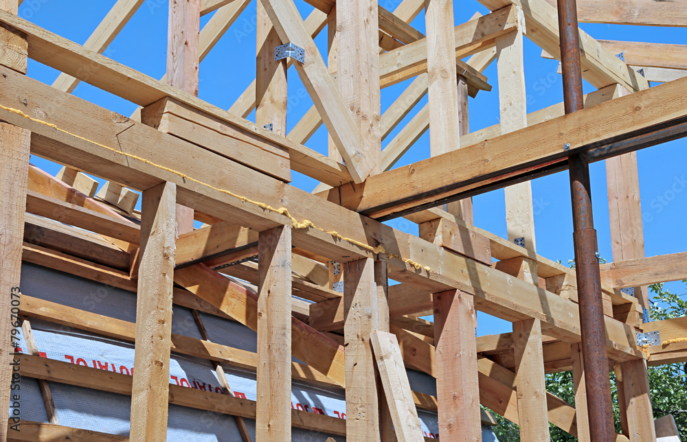 Installation of wooden beams at construction Installation of wooden beams at construction