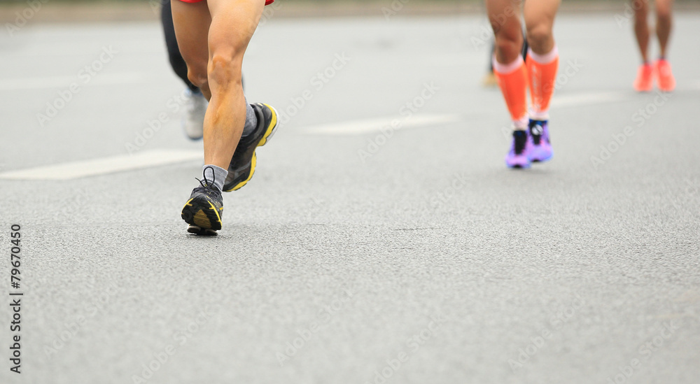 Fototapeta premium marathon runner legs running on city street