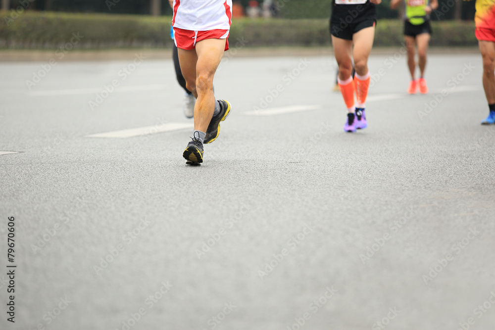 marathon runner legs running on city street