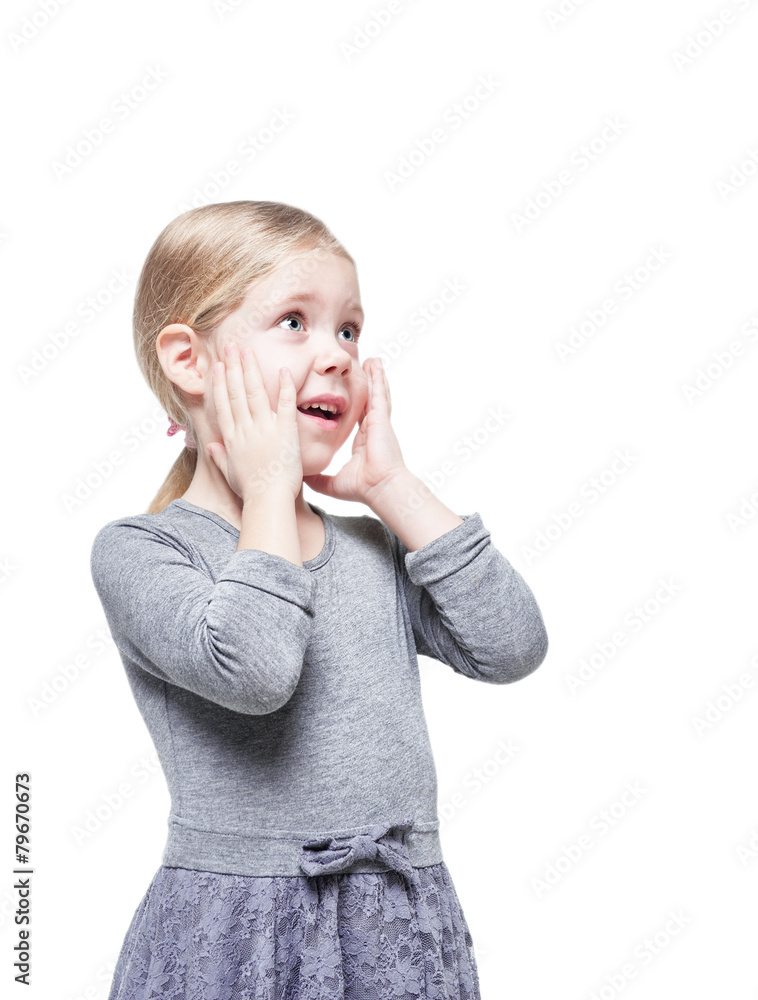 Beautiful little girl surprised looking up on something isolated Beautiful little girl surprised looking up on something isolated