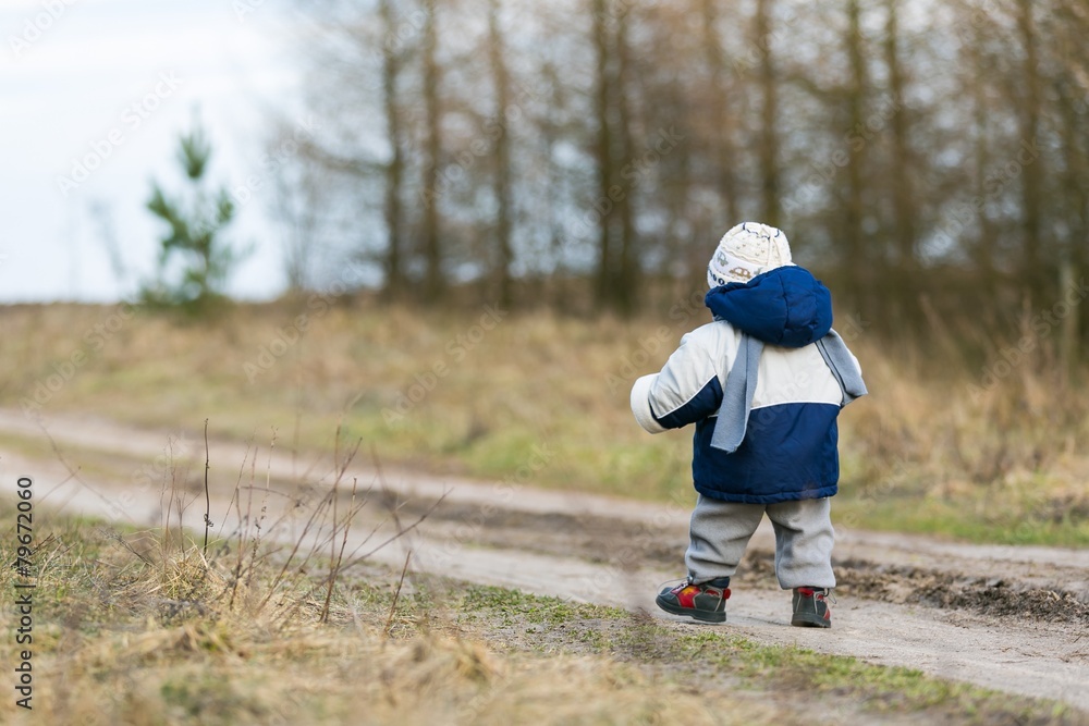 toddler child walking by rural sandy road toddler child walking by rural sandy road