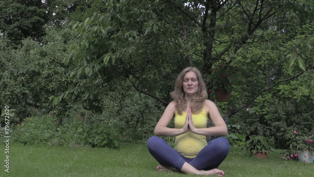 pregnant woman at yoga meditation in park. 6 months pregnant pregnant woman at yoga meditation in park. 6 months pregnant