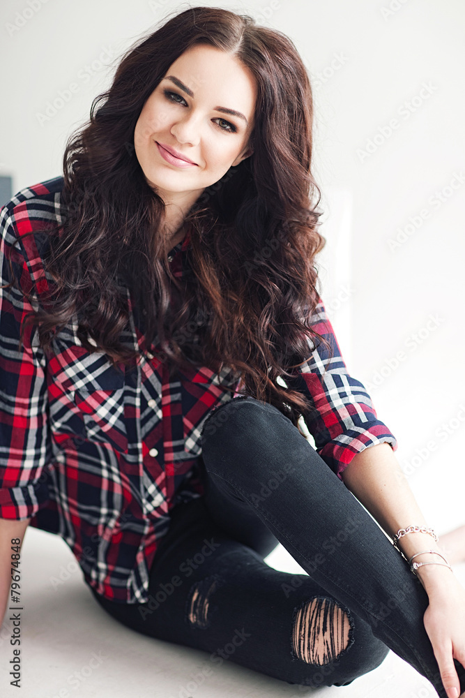 Young attractive woman in squared shirt posing in studio. Casual Young attractive woman in squared shirt posing in studio. Casual