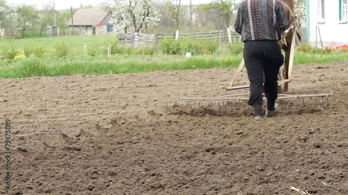 Farmer ploughing the field with horses
