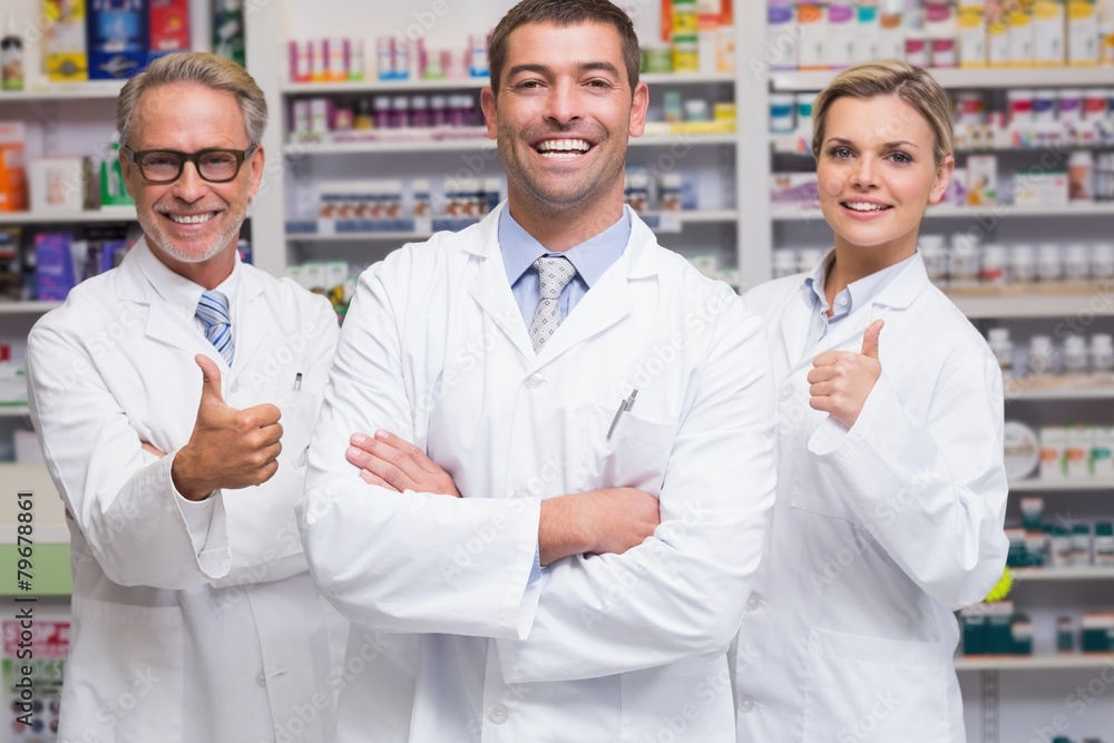 Team of pharmacists smiling at camera Team of pharmacists smiling at camera