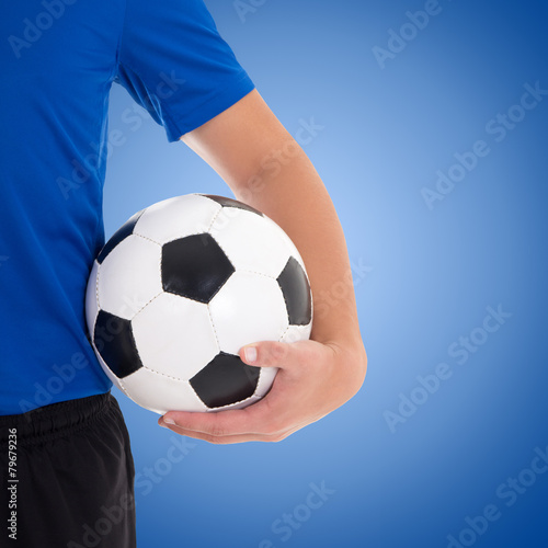 soccer ball in player's hand over blue