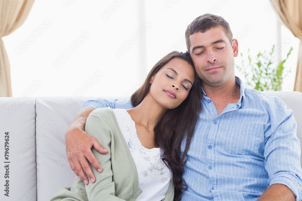 Couple with eyes closed sitting on sofa Couple with eyes closed sitting on sofa