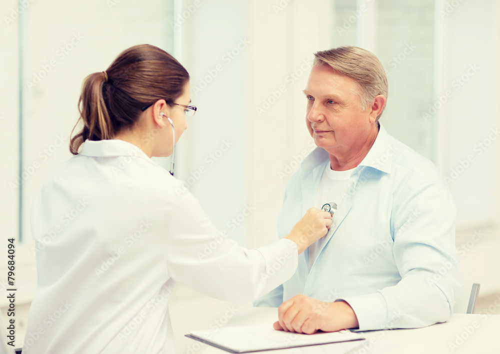 Fototapeta premium female doctor with old man listening to heart beat