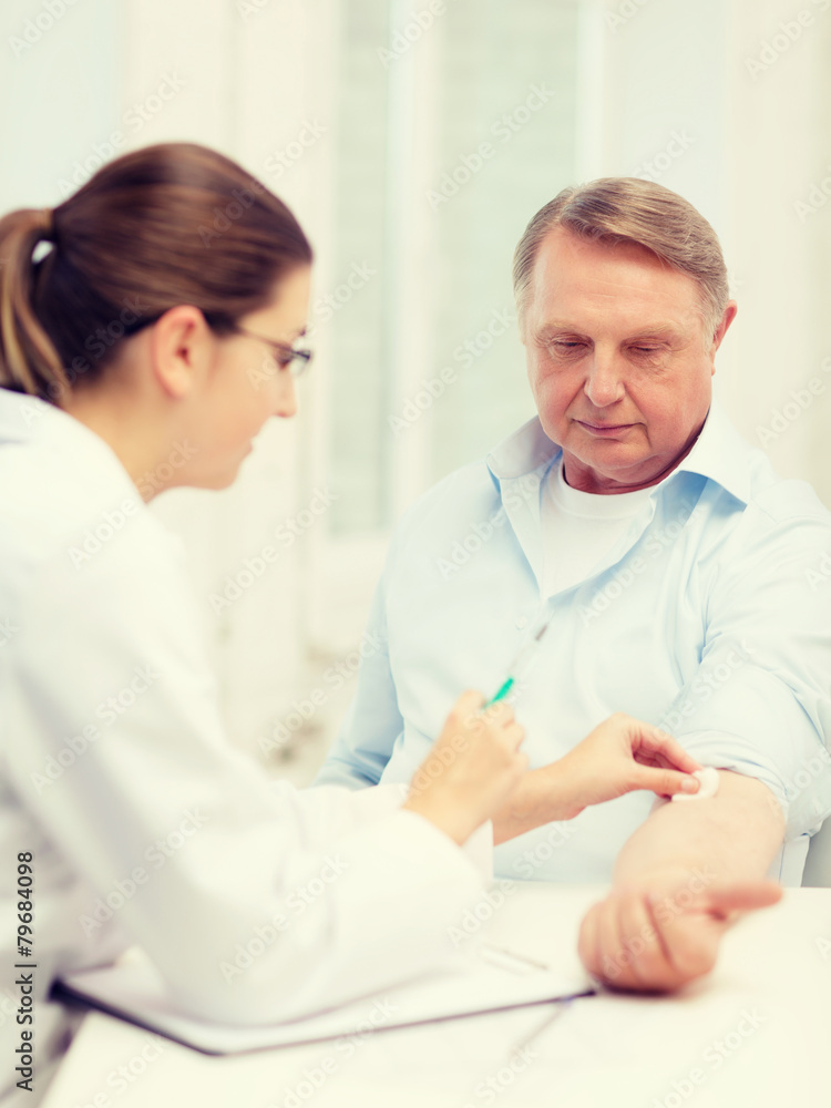 female doctor doing injection to old man female doctor doing injection to old man