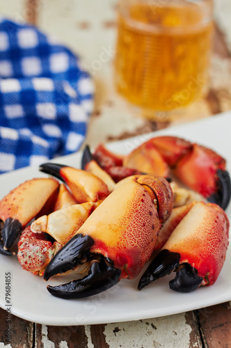 Boiled crab claws on a plate and beer