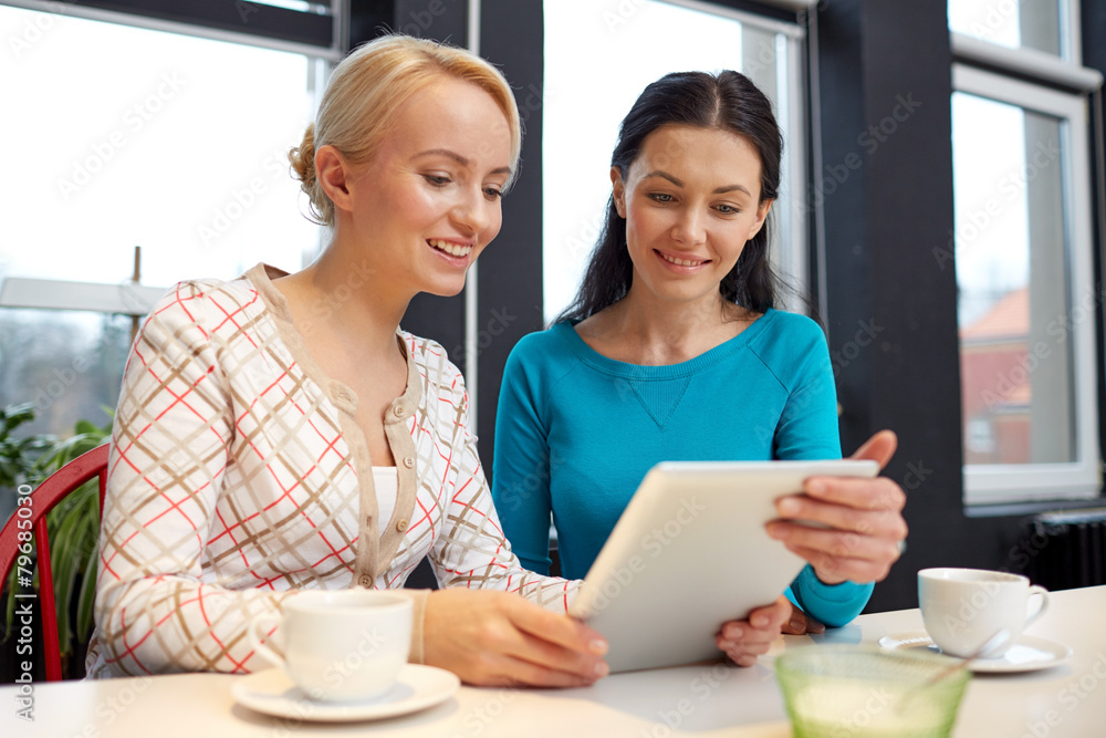 happy young women drinking tea or coffee at cafe