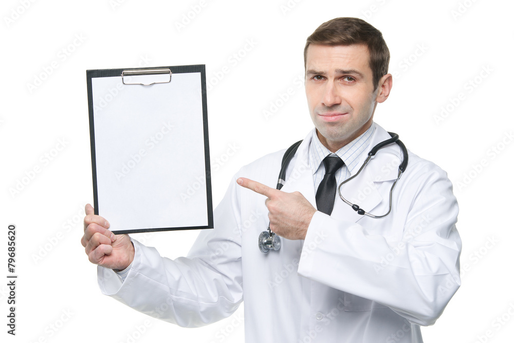 Smiling male doctor with stethoscope pointing finger to clipboar Smiling male doctor with stethoscope pointing finger to clipboar