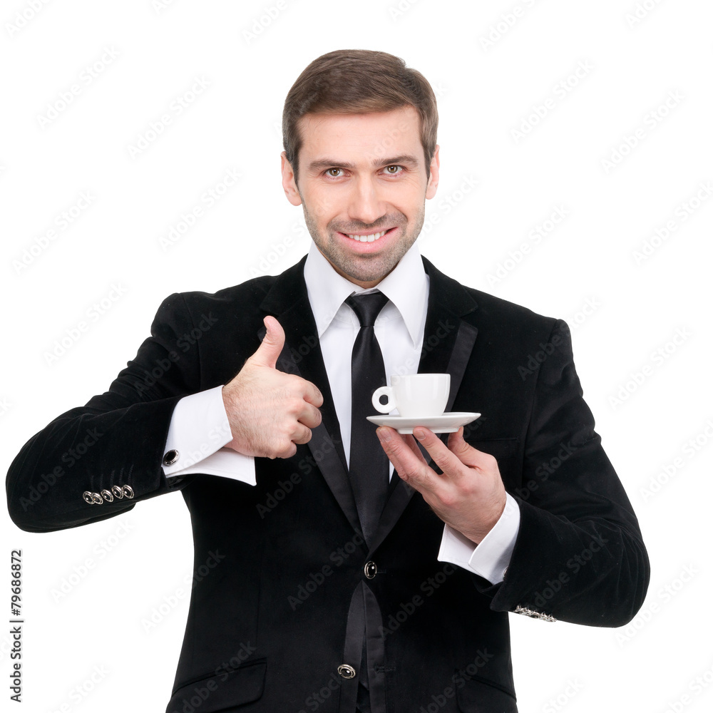 Perfect coffee. Handsome smiling businessman holding a cup of co Perfect coffee. Handsome smiling businessman holding a cup of co