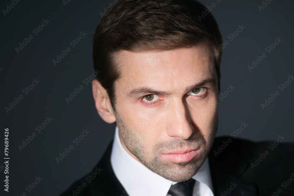 Studio portrait of thinking young business man. Top view Studio portrait of thinking young business man. Top view