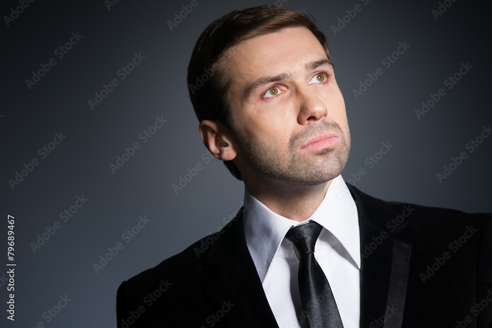Studio portrait of thinking young business man. In thought. Suit Studio portrait of thinking young business man. In thought. Suit