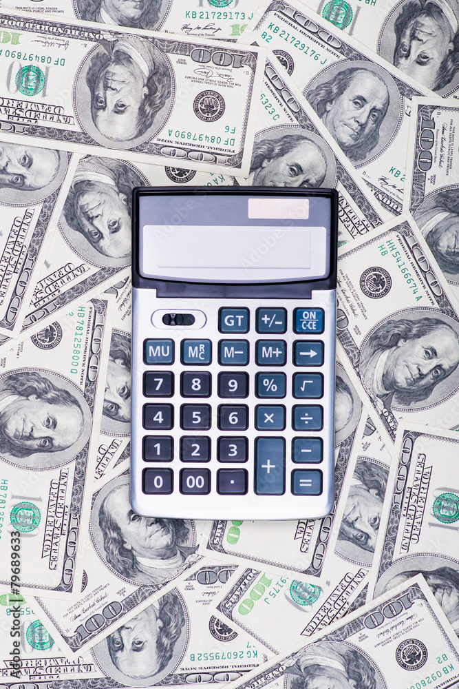 U. S. Dollars and calculator. Studio shot. U. S. Dollars and calculator. Studio shot.