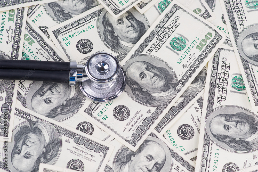 Stethoscope on one hundred US dollar bills. Stethoscope on one hundred US dollar bills.