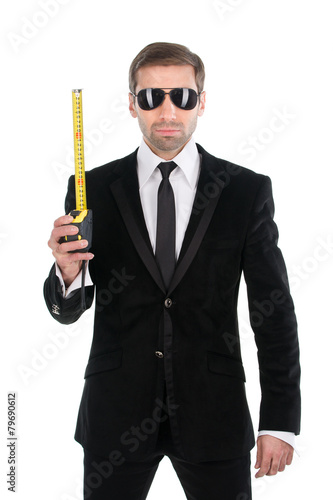 Stylish businessman in sunglasses with tape measure. Isolated on