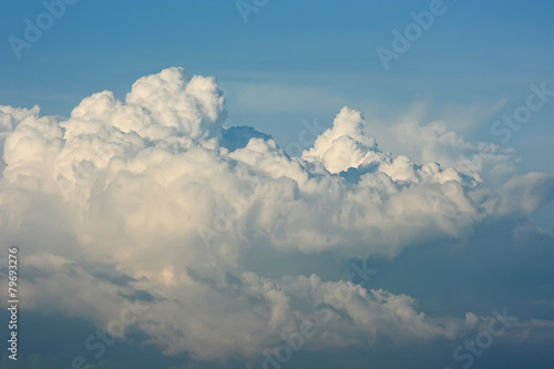 Cloudscape. White cumulus clouds are like a snow-covered mountain peaks.