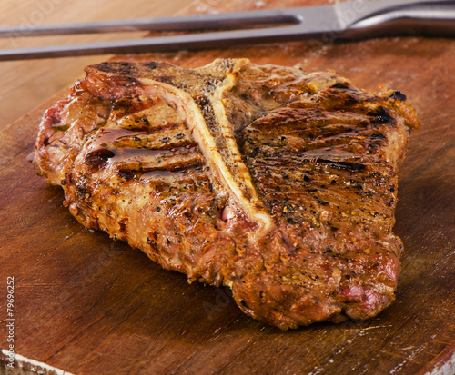 Grilled T-Bone Steak on a wooden table