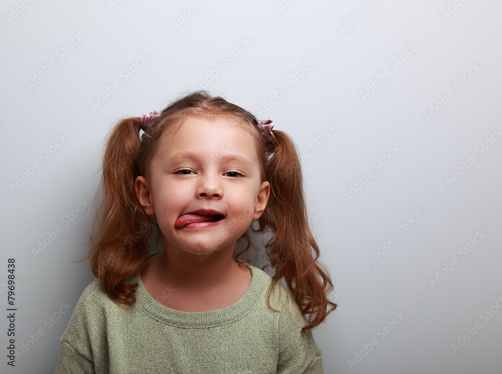 Fun cute kid girl showing the tongue with happy look Fun cute kid girl showing the tongue with happy look